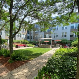a building with a well-landscaped lawn