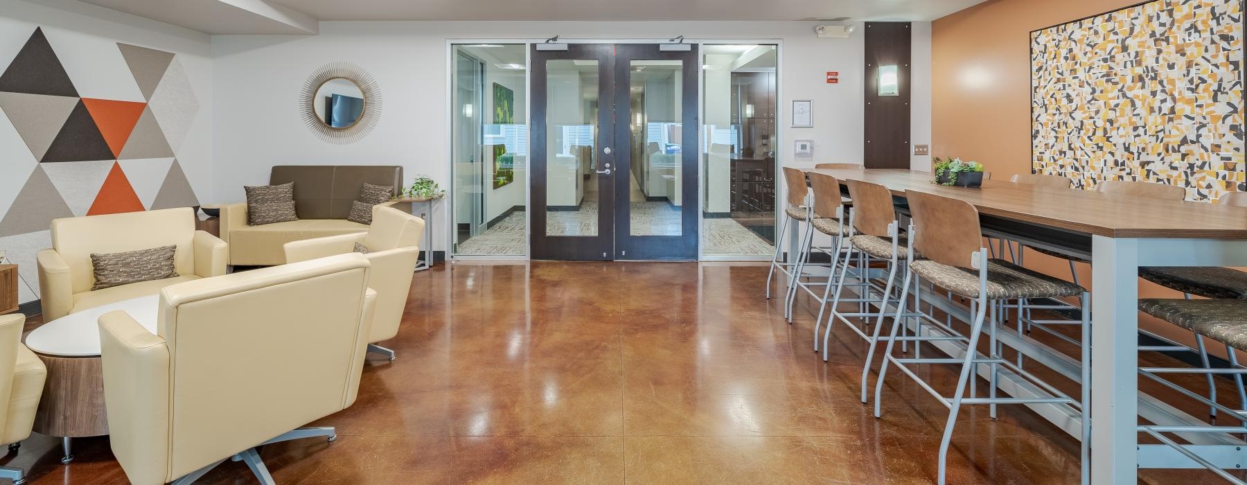 a room with a table chairs and a large glass door