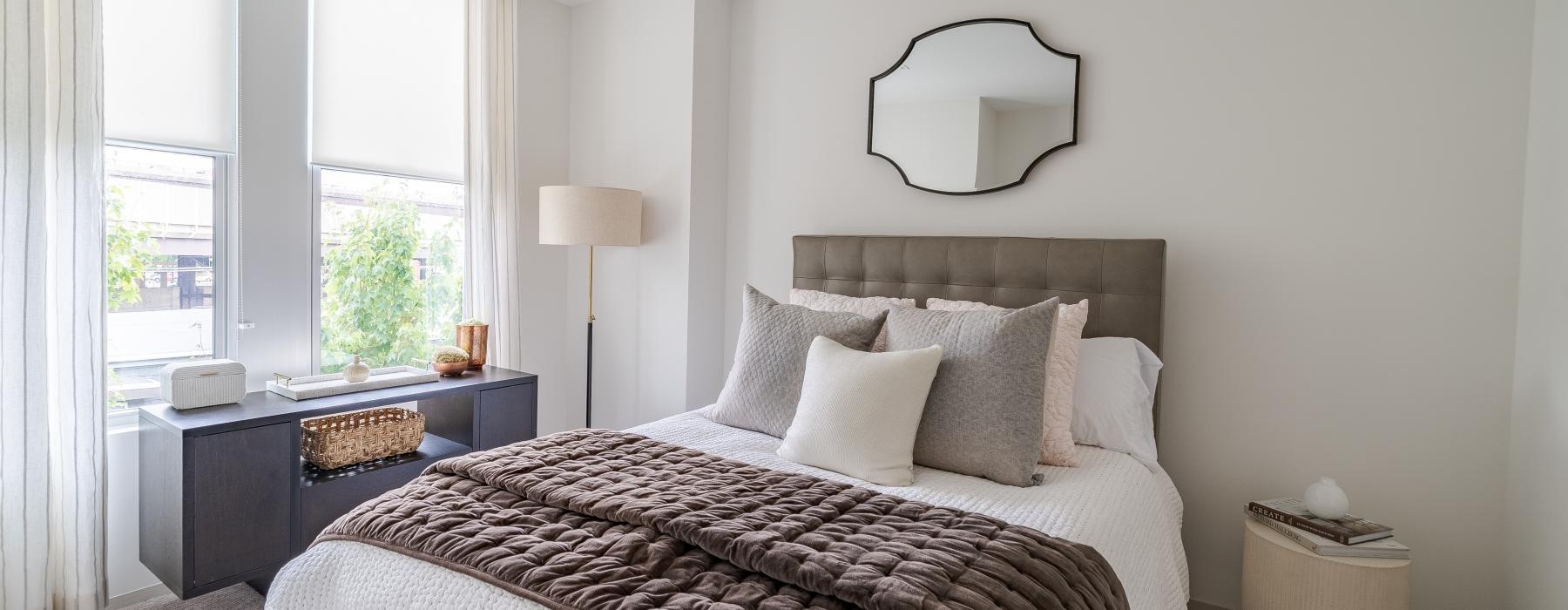 a bedroom with a bed and a mirror