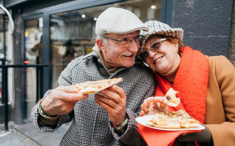 a couple eating pizza