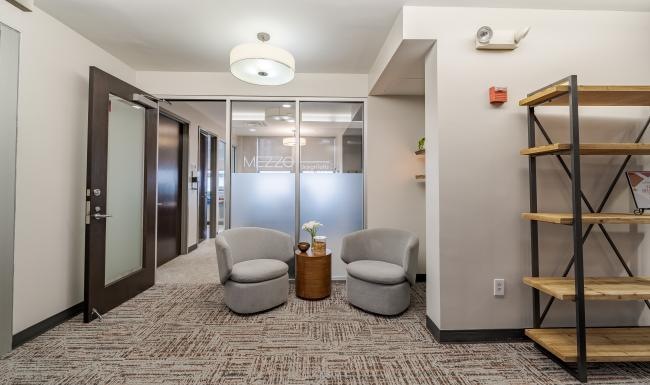 a room with a glass door and a chair and a table