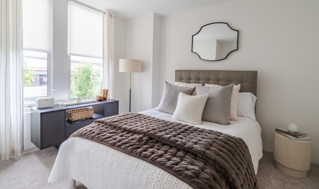 a bedroom with a bed and a mirror